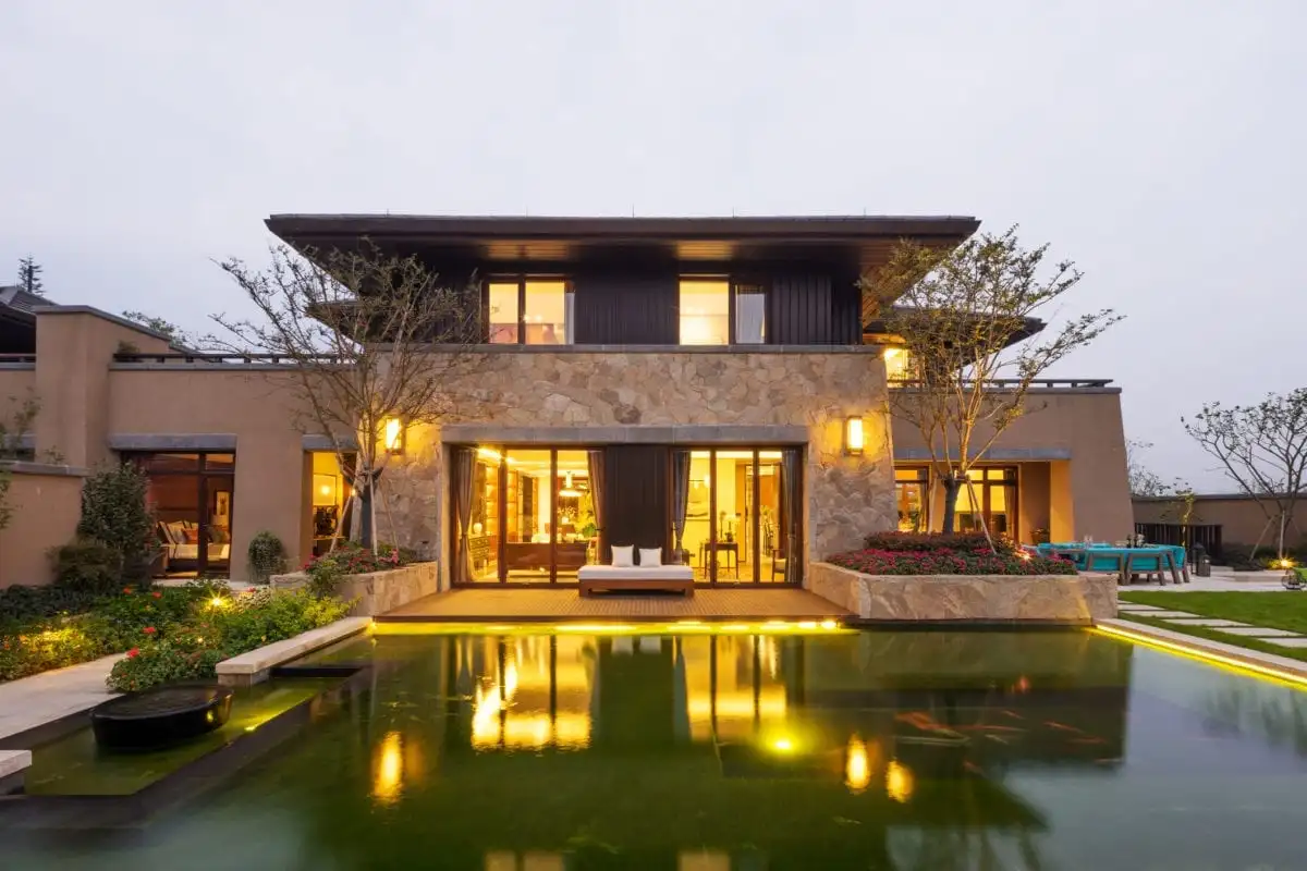 facade of modern building near pond at dusk | | Bay Property Management Group