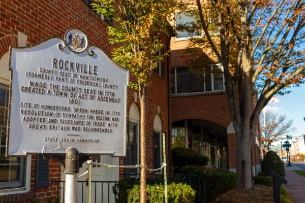 Rockville historical marker beside a brick building and trees with autumn leaves.