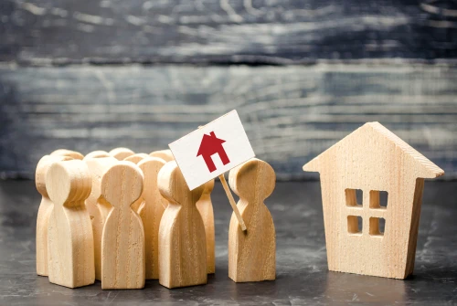Wooden figures representing rental occupancy standards in a residential property
