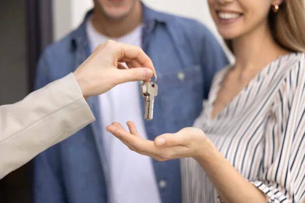 Property manager handing rental property keys to approved tenants