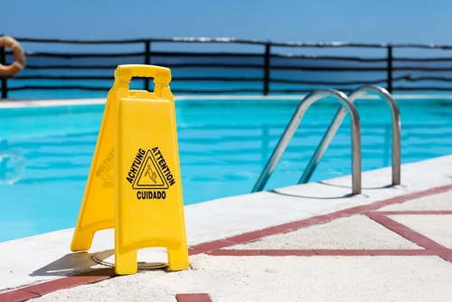 Swimming pool safety sign reminding tenants and guests to use caution