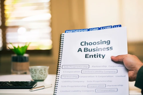Person holding a guide about choosing a business entity for real estate investing.
