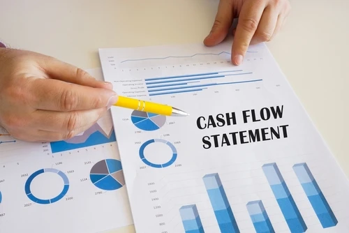 Investor reviewing a cash flow statement to calculate rental property ROI