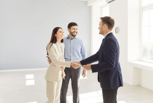 Property manager welcoming new tenants after preparing a vacant rental property for occupancy