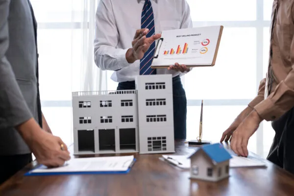 Real estate professionals reviewing rental property investment plans