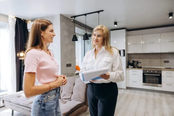 Property manager speaking with a tenant inside a rental home