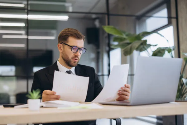 Property manager reviewing rental application documents at a desk