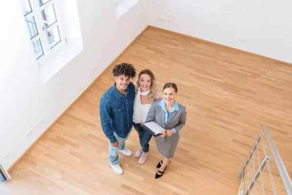 Renters viewing an empty rental property with a real estate professional