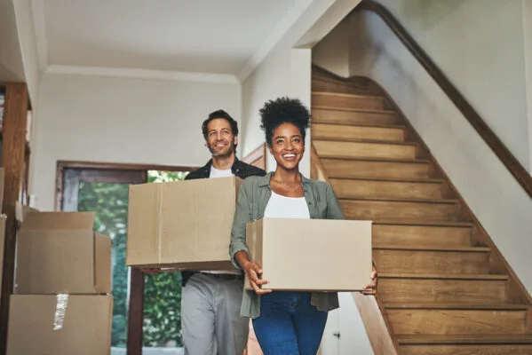 happy couple moving into a house