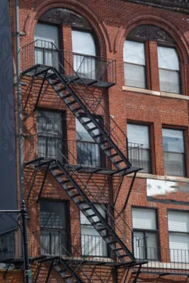 windows of an old building metal stair concrete brick apartment