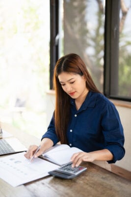 Investor reviewing lease documents and expenses with calculator during a lease audit