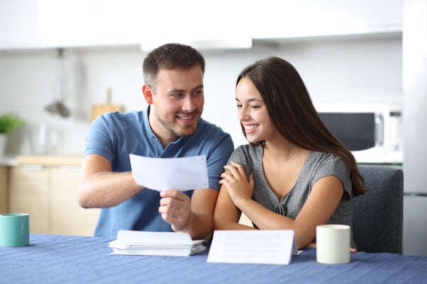 Couple reviewing rental fees and discussing if apartment admin fee is refundable if denied.