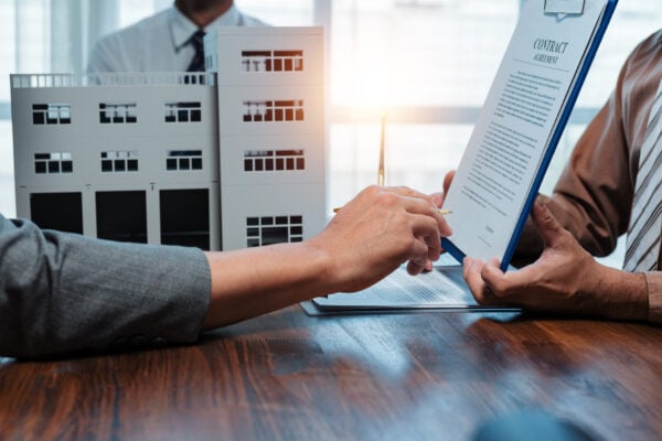 Landlord and tenant reviewing an evergreen lease agreement before renewal.