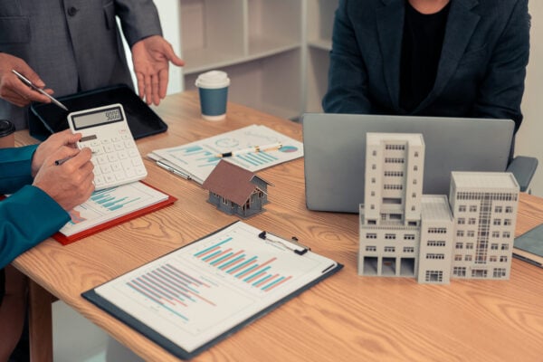 Real estate professionals reviewing pricing and investment details