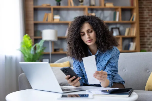 Woman reviewing income and expenses while checking apartment qualification requirements