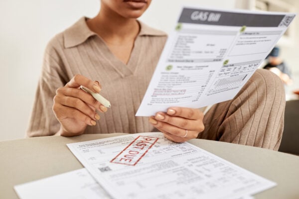Tenant reviewing past due rent notice and billing documents