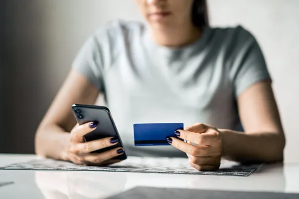 Tenant paying rent online with a credit card using a mobile phone.