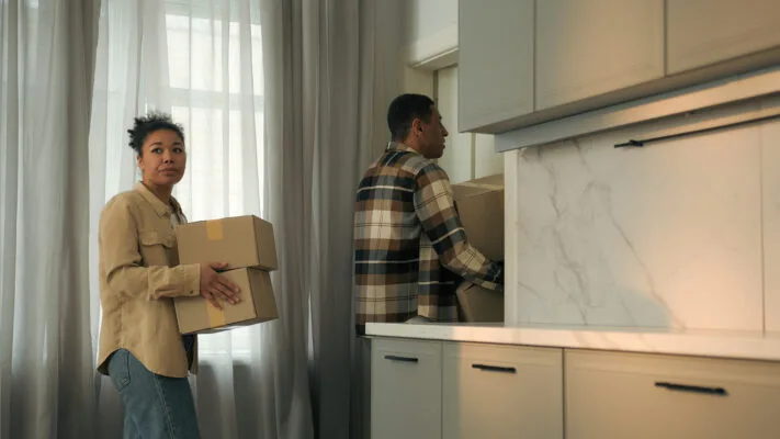 tenant packing boxes and moving out of apartment