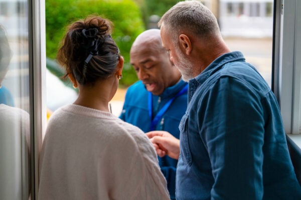 Landlord discussing issue with tenant at rental property door