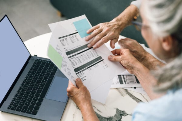 tenant reviewing rental application and financial documents on laptop
