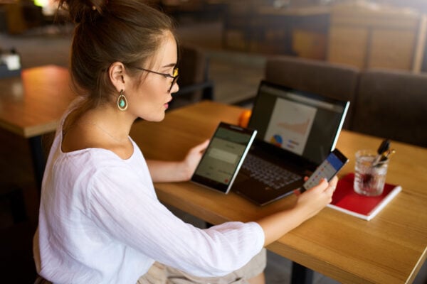 person comparing apartment options and rent prices on devices