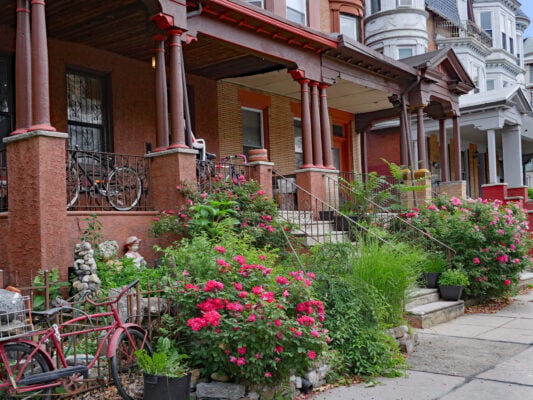 Philadelphia rowhomes with front porches and landscaping in a residential neighborhood