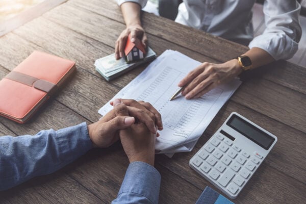 reviewing lease costs and renewal fee with calculator and documents