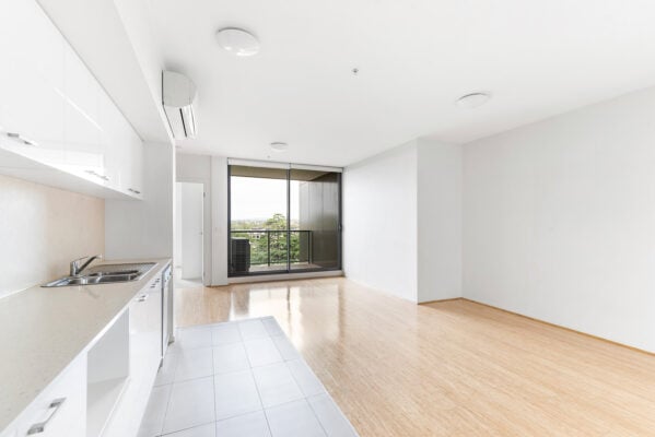 Empty apartment interior with open living space and kitchen ready for rent