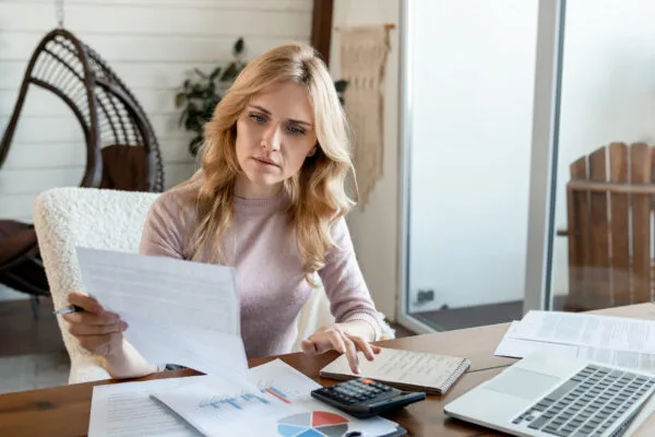 Remote landlord reviewing rental property documents and finances from home