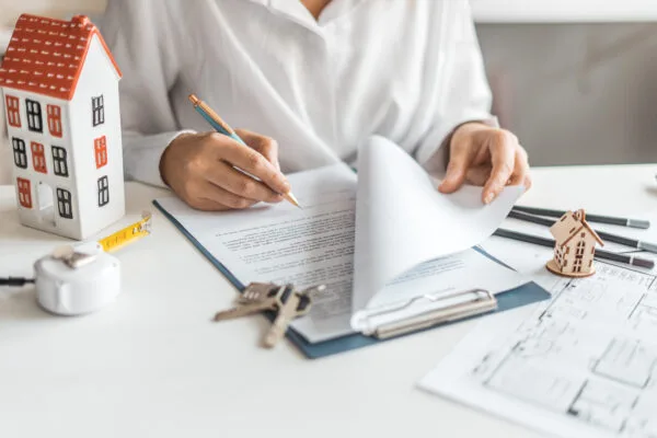 Landlord reviewing lease paperwork before making a lease renewal or non-renewal decision.