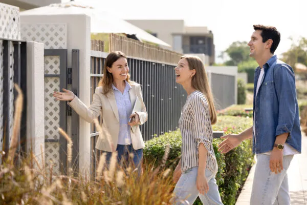 Property manager welcoming prospective tenants during the rental application process