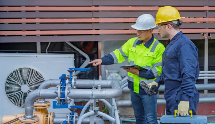 HVAC professionals inspecting a rental property cooling system
