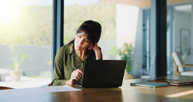 Property manager reviewing rental applications on a laptop
