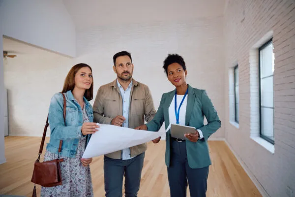 Prospective renters speaking with a property professional while viewing a rental home