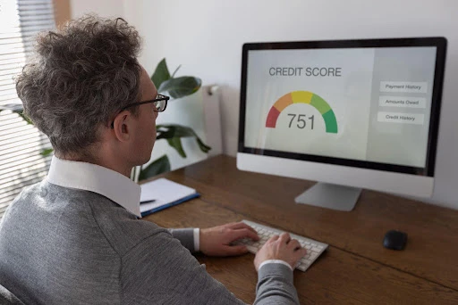 Landlord reviewing a credit score on a computer screen.