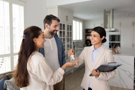 Property manager handing over keys to approved tenants after completing the screening process.