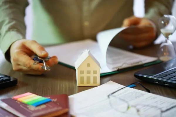 Landlord reviewing rental documents before screening prospective tenants.