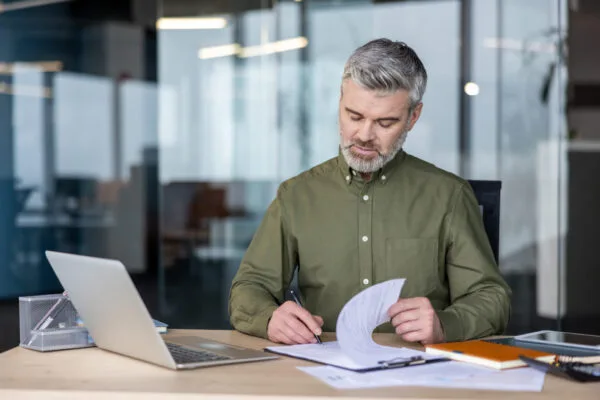 Rental property owner reviewing a property management agreement before signing
