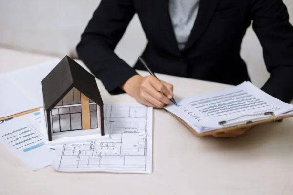 First-time real estate investor reviewing documents to purchase a rental property
