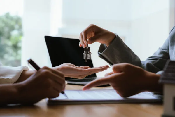 Rental property owner handing over keys after hiring a property management company