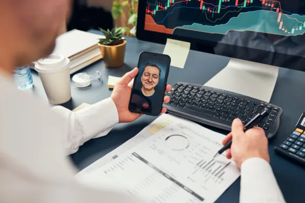 Real estate investor reviewing financial reports and property performance during a video call
