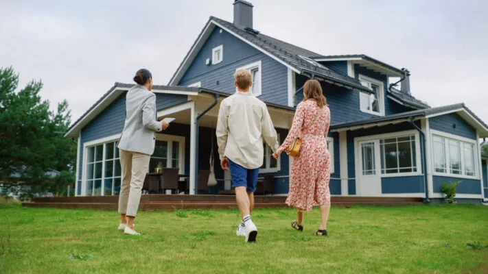 First-time real estate investors viewing a potential rental property with an agent